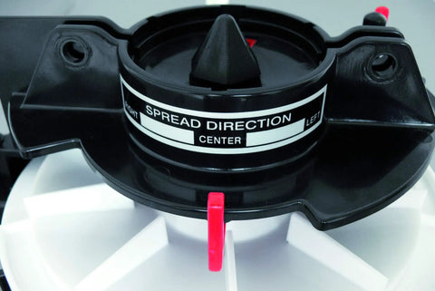 Close-up of 9 Kg Capacity Manual Spreader With Adjustable Strap And Crank, Red, showing spread direction control center part.