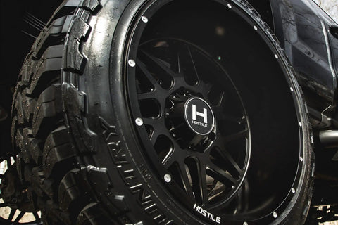 H108 Sprocket 22X12 Road Beast Rim Delivers 8X170 Bolt Lugs And -44 Offset with asphalt satin black coating on tire.