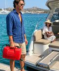 Man holding 3 Gallon Outboard Fuel Transfer Tank with Fuel Line, Grab N Go Portable Boat Fuel Kit on boat dock.