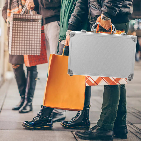 Rugged Aluminum Alloy Tool Case With Sturdy Carry Handle For Mechanics And Weekend Warriors, held among shopping bags.