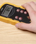 Hand holding Pinless Wood Moisture Meter S300 With Shallow Scan, 0.25 Inch Readings; digital display on wooden surface