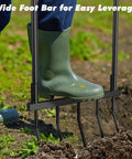 Using Heavy Duty 5 Tine U Shaped Broadfork Garden Tool with wide foot bar for leverage in soil; 20 inch wide, 55 inch tall.