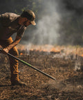 Man using Powerful Workhorse Metal Bow Rake With Heavy Duty Steel Construction And No Slip H Grip Ergonomic Handle for yard work
