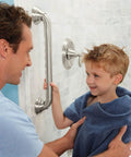 Man helping child near 24 Inch Handicap Grab Bar For Bath And Shower With Curled Grip No Slip Brushed Nickel Heavy Duty Stainless Steel