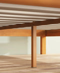 Bottom view of Top Tier Queen Platform Bed Frame With Tufted Fabric Headboard, showing heavy steel base and hardwood slats.
