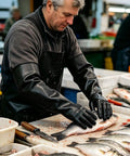 Heavy Duty 22 Inch Black Latex Gloves Chemical Resistant Rubber Gauntlets For Industrial Work And Dishwashing Savage Grip in use while preparing fish.