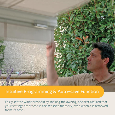 Person demonstrating Eolis 3D WireFree RTS Wind Sensor for Awnings installation and setup under an awning.