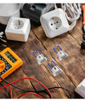 30 Pack Recessed Lighting Clips And Lamp Trim Springs For LED Panels on wooden surface with electrical tools nearby
