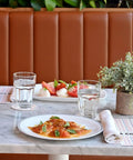 Dining setup with Stackable 12.5oz Glass Tumblers Set Of 6 For Sodas Juices Milk Beer And Spirits on a marble table with food