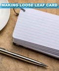 Stack of loose-leaf index cards with metal ring and pen on desk for note-taking and organizing