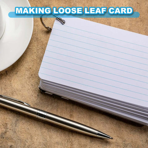 Stack of loose-leaf index cards with metal ring and pen on desk for note-taking and organizing