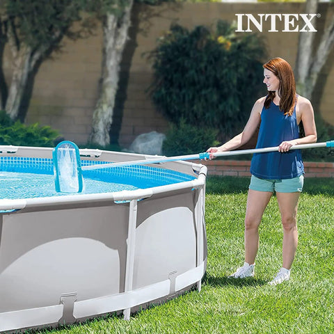 Woman using Deluxe Above Ground Pool Maintenance Kit With Vacuum For 800 GPH Flow Rate 110 Inch Telescoping Pole Wall Brush