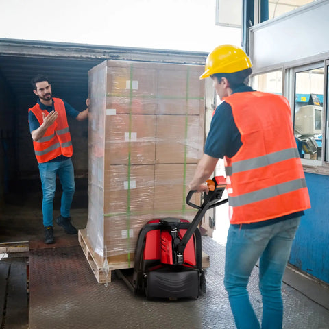 Powerhouse Full Electric Pallet Jack Bundle With Amps Boosting 4800 Lbs Capacity And 48 Inch Forks Plus Huge 48 Volt Lithium Battery in use at warehouse.