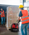 Two warehouse workers using a Powerful 48-Volt Electric Pallet Jack For Smooth Moves Heavy Duty Forklift to move a pallet of boxes.