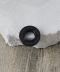 Black rubber oil seal, 12x24x4.5 mm, double-lip rotary shaft seal, front view.