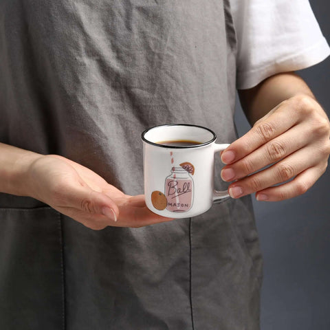 Person holding small ceramic espresso cup, possibly part of Four Pack Ceramic Demitasse Espresso Cups, 4.23 Oz Small Coffee Mugs for Espresso Machines and Home Coffee Makers, Microwave and Dishwasher Safe, Great for That Quick Caffeine Fix.
