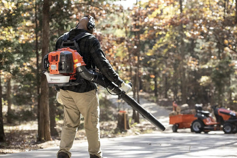 Man using Gas Backpack Leaf Blower 65.6cc 3.81HP 2-Cycle With 890CFM And 232MPH, Beast Yard Cleanup Machine in a forest area
