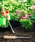 Two Pronged Dandelion Weeder Puller Tool With Wood Handle Stainless Steel Garden Weed Remover in garden setting.