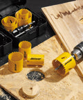 Bi-Metal Hole Saw Kit 7-Piece Set with Mandrels and Bits showing drill cutting wood, blades, and case.