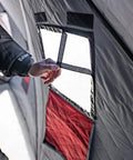 Quickfish Six Person Portable Pop Up Ice Fishing Shelter With Fully Quilted Insulation No Trip Door and Deluxe Anchors For Hell Of A Winter Setup In Red Black, showing interior window detail.