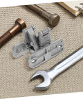 TEHAUX concealed stainless steel door hinges with mounting plates and pins, shown with a wrench on a woven mat