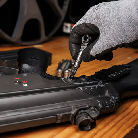Using Ultra Compact One Quarter Inch Ratchet Wrench For Tight Spaces Stainless Steel EDC Tool on a black mechanical device