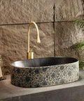 Retro Ceramic Vessel Sink for Bathroom, Oval Above-Counter Wash Vanity Sink with Accessories against stone backdrop.
