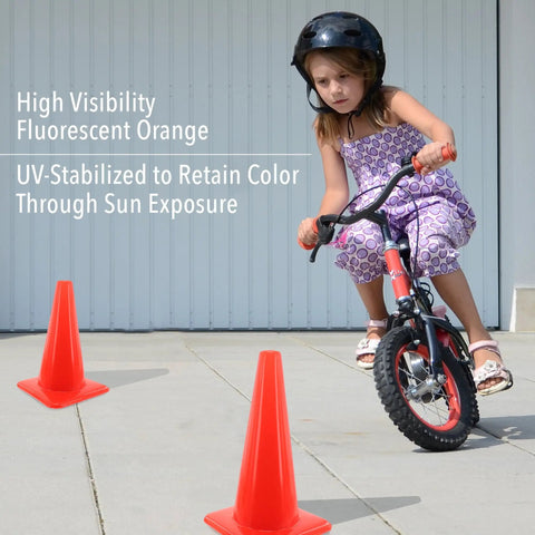 Child riding a bike between two bright orange 18 inch traffic cones built tough for weather resistance, UV-stabilized for high visibility.