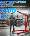 Easy Roll Three Ton Folding Hydraulic Engine Hoist Packs A Beastly Nine Ton Pump And Four Swift Casters Heavy Duty Alloy Steel Cherry Picker Crane lifting engine in auto shop.