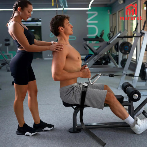 Man using Universal Belt Squat Collar For Nordic Hamstring Curl On Bench in gym, demonstrating seated exercise setup.