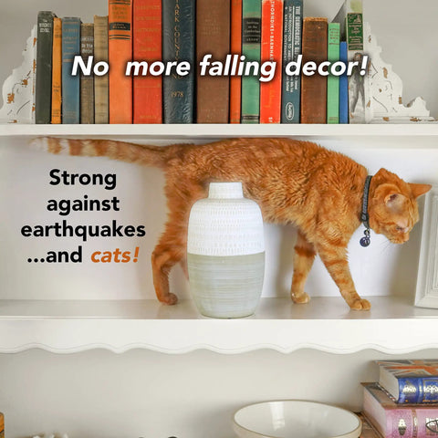 Cat on shelf with vase secured by Clear Museum Wax Two Ounce For Keeping Antiques And Collectibles From Falling On Wood Surfaces Easy To Apply And Remove Non Toxic Reusable Conservator Grade