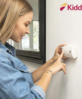 Carbon Monoxide Detector Battery Powered For Travel Or Home With 85 Decibel Alarm And LED Status Indicators Electrochemical Sensor No Wiring Required Two AA Batteries Included installed on wall with woman testing it