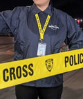 Person in detective jacket with lanyard and police line tape, part of Hands-On CSI Crime Scene Investigation Kit For STEM Classrooms.
