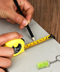 Person measuring with a tape measure and pencil from the 158 Piece Home Tool Set With Durable Chrome Finish Tools And Easy Carry Round Pouch.