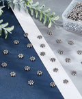 Assorted Antique Silver Daisy Flower Spacer Beads 6mm, 300Pcs Tibetan Style for DIY Jewelry Crafting on fabric background