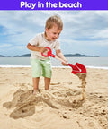 Child playing with Three Piece Metal Beach Shovel Set For Kids, 16 Inch Sand Shovels with Wooden Handles at the beach