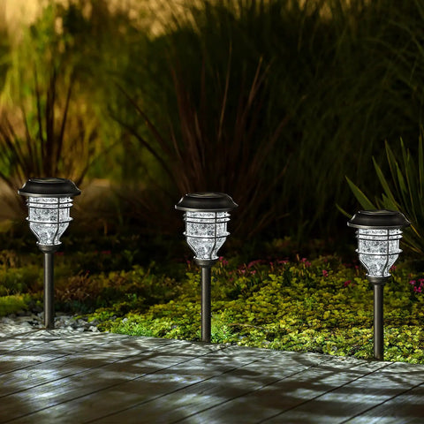 Bright Solar Pathway Lights 4 Pack Outdoor Waterproof Crackle Glass Aluminum Stake Lights For Garden Walkway Landscape Decor Solar Powered Easy Install, illuminating a garden path at night.