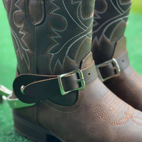 Two Pack Handmade Leather Spur Straps For Western Riding on brown cowboy boots, showing full grain leather and buckle detail.