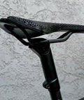 7x10 Seatpost Ear Clamp Titanium Bolt Kit For Oval Carbon Rails installed on a bike, highlighting saddle attachment.