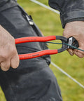 Hands using CoBolt Compact Bolt Cutter With Notched Blade For Heavy Duty Cutting Up To 0.170 Inch Diameter on wire outdoors