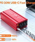 Heavy Duty Car Power Inverter Dc 12V To Ac 110V With Pd Fast Charging Dual Usb Ports and Two Standard Outlets on a table.