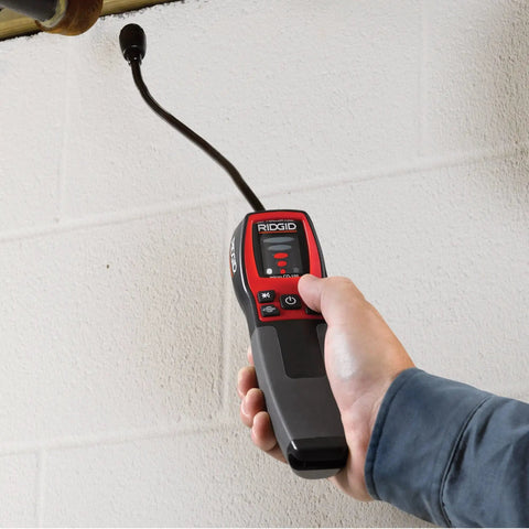 Person using Combustible Gas Handheld Detector With 16 Inch Flexible Probe Visual Audible And Vibration Alarms on a pipe
