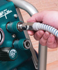 Connecting Ultra Lightweight Contractor Air Hose With True Kick Ass Kink Resistance to an air compressor, showcasing heavy-duty use.