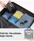 Packing a suitcase with 35L Foldable Waterproof Backpack For Outdoor Adventures, shown in compact form next to folded jeans.