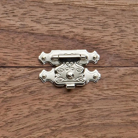 Decorative Jewelry Box Latch With No Sweat Setup For Diy Woodworking, small metal clasp on a wooden surface.