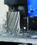 Hougen HMD904S magnetic drill on metal worktable with spiral metal shavings