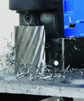 Slick Operation 115 Volt Magnetic Mag Drill With Built In 16 Oz Gravity Fed Coolant Bottle making holes in steel with metal shavings.