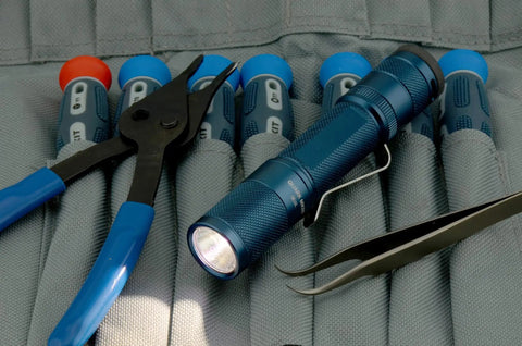 Quark LED Flashlight Pocket EDC With Clip, High CRI Beam, on tool case next to pliers and tweezers