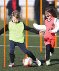 Children playing soccer using six 5ft adjustable agility poles for soccer basketball football dog and horse training outdoor orange set.
