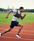 Man running on track wearing Outdoor Chest Bag For Men Concealed Vest Holster Fits Most Pistols Adjustable Anti Theft EDC Pack